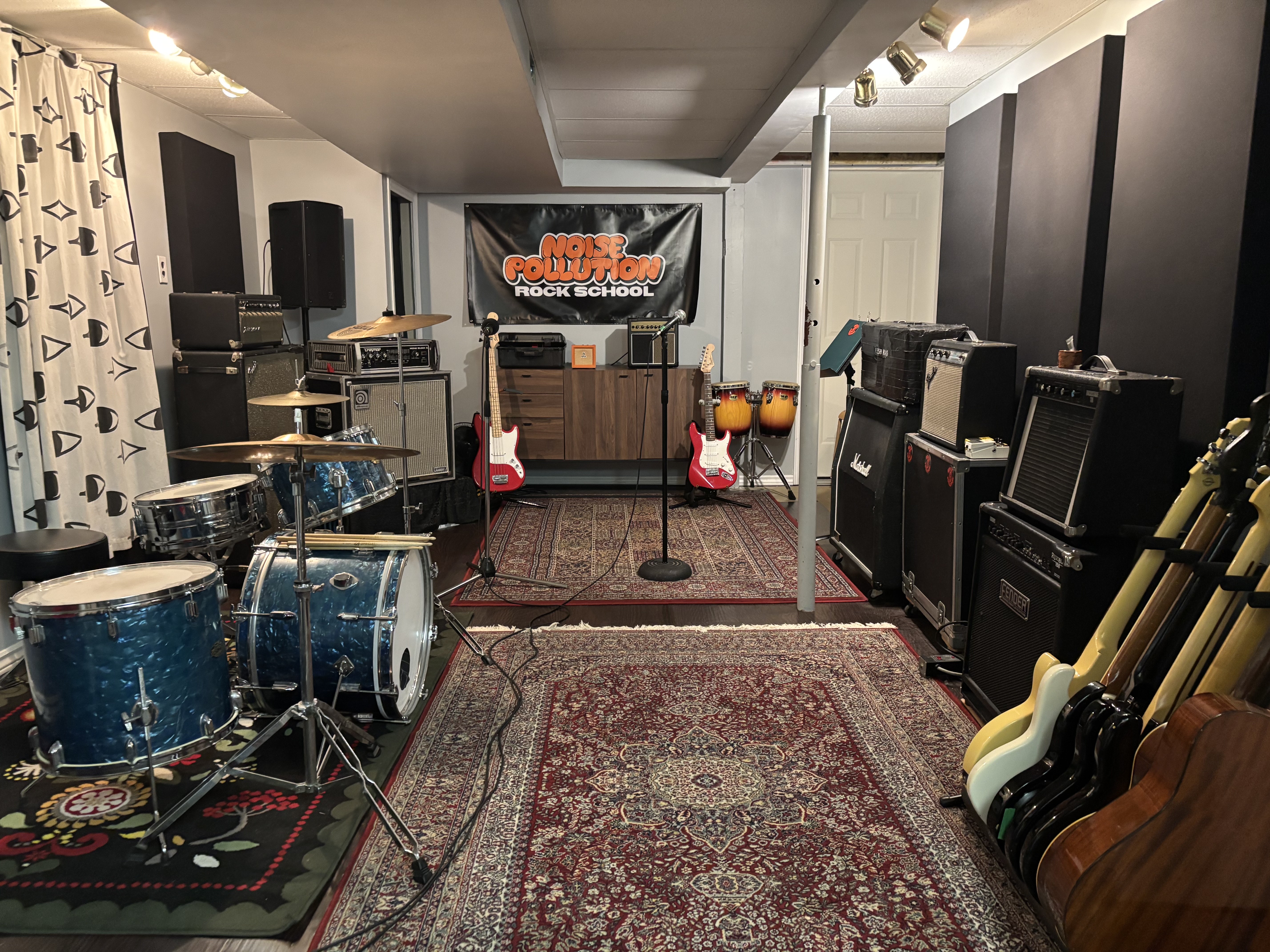 noise pollution rock school's studio space with all the different instruments like drums, guitar, bass, and keyboards